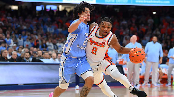 Feb 13, 2024; Syracuse, New York, USA; Syracuse Orange guard JJ Starling (2) drives to the basket as North Carolina Tar Heels guard Elliot Cadeau (2) defends during the second half at the JMA Wireless Dome. Mandatory Credit: Rich Barnes-Imagn Images