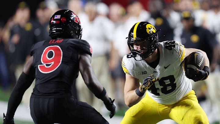 Sep 19, 2025; Piscataway, New Jersey, USA; Iowa Hawkeyes tight end Zach Ortwerth (48) gains yards after catch as Rutgers Scarlet Knights defensive back Jett Elad (9) defends during the second half at SHI Stadium. Mandatory Credit: Vincent Carchietta-Imagn Images