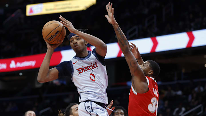 Dec 8, 2024; Washington, District of Columbia, USA; Washington Wizards guard Bilal Coulibaly (0) leaps to pass the ball as Memphis Grizzlies guard Marcus Smart (36) defends in the first quarter at Capital One Arena. Mandatory Credit: Geoff Burke-Imagn Images