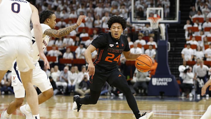 Feb 5, 2024; Charlottesville, Virginia, USA; Miami (Fl) Hurricanes guard Nijel Pack (24) dribbles the ball as Virginia Cavaliers guard Dante Harris (1) defends during the first half at John Paul Jones Arena. Mandatory Credit: Amber Searls-Imagn Images