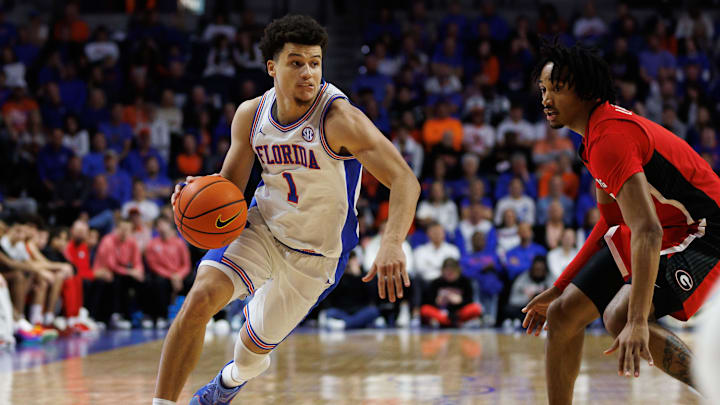 Jan 25, 2025; Gainesville, Florida, USA; Florida Gators guard Walter Clayton Jr. (1) drives to the basket while Georgia Bulldogs guard Tyrin Lawrence (7) defends during the second half at Exactech Arena at the Stephen C. O'Connell Center. Mandatory Credit: Matt Pendleton-Imagn Images