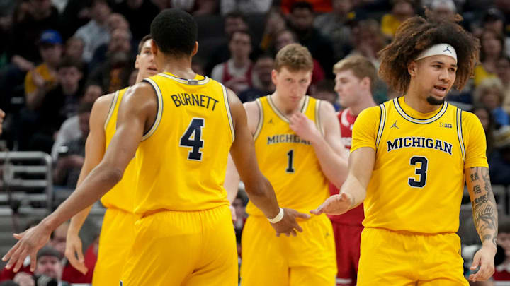 Michigan Wolverines guard Tre Donaldson (3) high fives guard Nimari Burnett (4) during the first half of the 2025 TIAA Big Ten Men’s Basketball Tournament final game against the Wisconsin Badgers on Sunday, March 16, 2025, at Gainbridge Fieldhouse in Indianapolis. Michigan defeated Wisconsin 59-53.