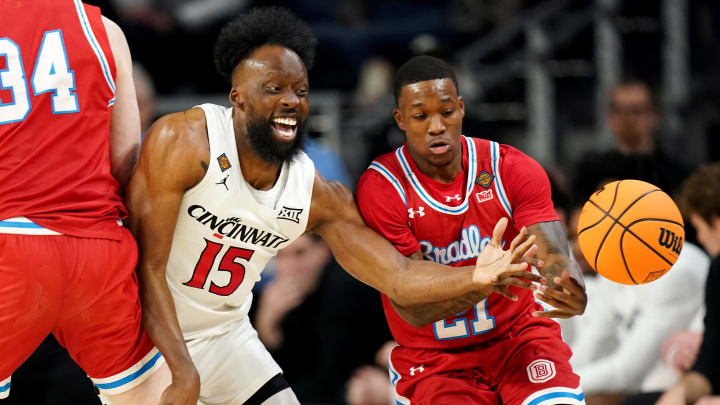 Cincinnati Bearcats forward John Newman III (15) pokes the ball way from Bradley Braves guard Duke Deen (21) in the first half of a college basketball game during a second-round game of the National Invitation Tournament,, Saturday, March 23, 2024, at Fifth Third Arena in Cincinnati.