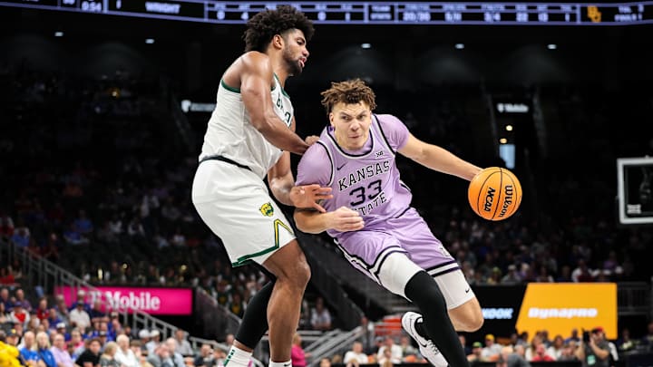 Mar 12, 2025; Kansas City, MO, USA; Kansas State Wildcats guard Coleman Hawkins (33) drives to the basket around Baylor Bears forward Norchad Omier (15) during the second half at T-Mobile Center. Mandatory Credit: William Purnell-Imagn Images