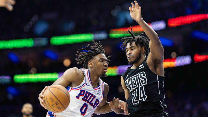 Apr 14, 2024; Philadelphia, Pennsylvania, USA; Philadelphia 76ers guard Tyrese Maxey (0) drives against Brooklyn Nets guard Cam Thomas (24) during the third quarter at Wells Fargo Center. Mandatory Credit: Bill Streicher-Imagn Images