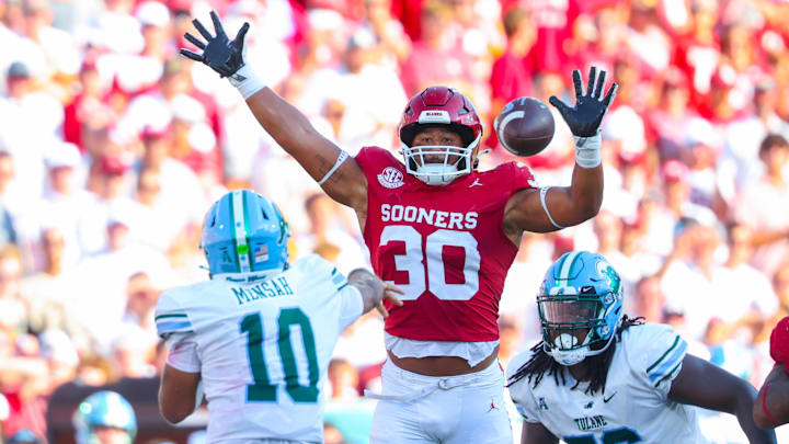 Sep 14, 2024; Norman, Oklahoma, USA;  Oklahoma Sooners defensive lineman Trace Ford (30) defends a pass by Tulane Green Wave quarterback Darian Mensah (10) during the second half at Gaylord Family-Oklahoma Memorial Stadium.  