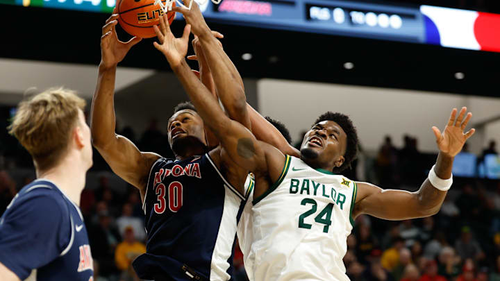 Feb 24, 2026; Waco, Texas, USA;  Baylor Bears guard Tounde Yessoufou (24) and Arizona Wildcats forward Tobe Awaka (30) battle for a rebound during the second half at Paul and Alejandra Foster Pavilion. Mandatory Credit: Chris Jones-Imagn Images
