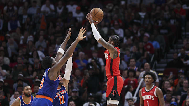 Nov 4, 2024; Houston, Texas, USA; Houston Rockets guard Jalen Green (4) shoots the ball as New York Knicks forward OG Anunoby (8) and guard Jalen Brunson (11) defend during the fourth quarter at Toyota Center. Mandatory Credit: Troy Taormina-Imagn Images