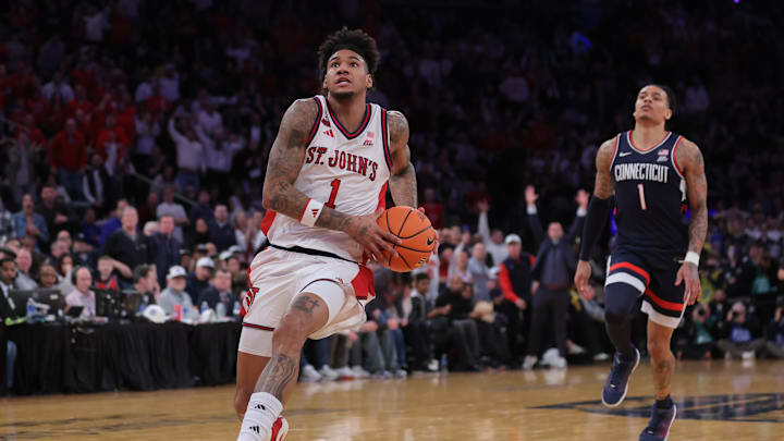 Mar 14, 2026; New York, NY, USA; St. John's basketball forward Dillon Mitchell (1) pushes the ball up court as Connecticut Huskies guard Solo Ball (1) trails on the play during the second half of the men's Big East Conference Tournament Championship at Madison Square Garden. Mandatory Credit: Brad Penner-Imagn Images
