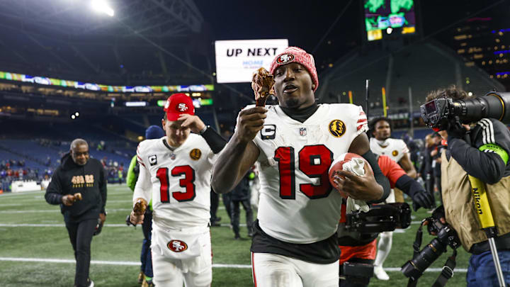 Nov 23, 2023; Seattle, Washington, USA; San Francisco 49ers wide receiver Deebo Samuel (19) eats a turkey leg as he and quarterback Brock Purdy (13) jog to the locker room following a 31-13 victory against the Seattle Seahawks at Lumen Field. Mandatory Credit: Joe Nicholson-Imagn Images