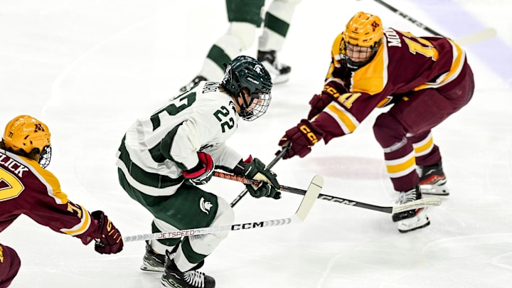Michigan State's Isaac Howard, left, moves the puck as Minnesota's Oliver Moore, right, defends during the first period on Friday, Jan. 26, 2024, at Munn Arena in East Lansing.