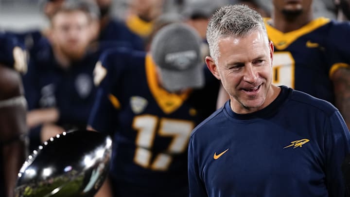 Dec 20, 2022; Boca Raton, Florida, USA; Toledo Rockets head coach Jason Candle stands next to the Boca Raton Bowl Trophy after winning against the Toledo Rockets in the 2022 Boca Raton Bowl at FAU Stadium. Mandatory Credit: Rich Storry-Imagn Images