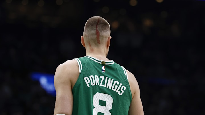 Apr 23, 2025; Boston, Massachusetts, USA; Boston Celtics center Kristaps Porzingis (8) returned to the court to shoot fouls shots after being cut by an elbow during the second half of game two of the first round of the 2024 NBA Playoffs against the Orlando Magic at TD Garden. Mandatory Credit: Winslow Townson-Imagn Images
