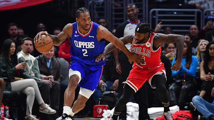 Mar 27, 2023; Los Angeles, California, USA; Los Angeles Clippers forward Kawhi Leonard (2) moves the ball against Chicago Bulls guard Patrick Beverley (21) during the first half at Crypto.com Arena. Mandatory Credit: Gary A. Vasquez-Imagn Images