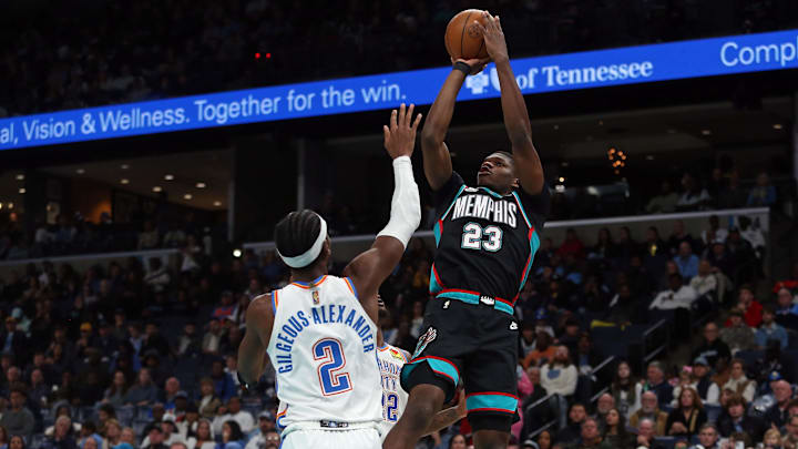 Nov 9, 2025; Memphis, Tennessee, USA; Memphis Grizzlies forward Cedric Coward (23) shoots as Oklahoma City Thunder guard Shai Gilgeous-Alexander (2) defends during the third quarter at FedExForum. Mandatory Credit: Petre Thomas-Imagn Images