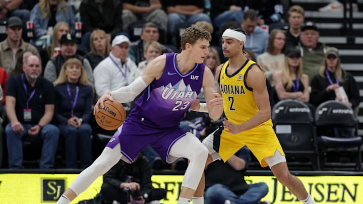 Feb 3, 2025; Salt Lake City, Utah, USA;  Utah Jazz forward Lauri Markkanen (23) protects the ball from Indiana Pacers guard Andrew Nembhard (2) during the second quarter at Delta Center. Mandatory Credit: Chris Nicoll-Imagn Images