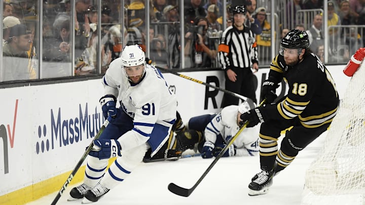 May 4, 2024; Boston, Massachusetts, USA; Toronto Maple Leafs center John Tavares (91) controls the puck ahead of Boston Bruins center Pavel Zacha (18) during the third period in game seven of the first round of the 2024 Stanley Cup Playoffs at TD Garden. Mandatory Credit: Bob DeChiara-Imagn Images