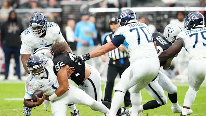 Oct 12, 2025; Paradise, Nevada, USA; Las Vegas Raiders defensive tackle Leki Fotu (95) sacks Tennessee Titans quarterback Cam Ward (1) during the second half at Allegiant Stadium. Mandatory Credit: Stephen R. Sylvanie-Imagn Images