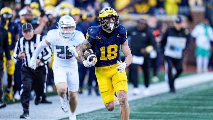Michigan tight end Colston Loveland (18) runs against Oregon linebacker Bryce Boettcher (28) during the first half at Michigan Stadium in Ann Arbor on Saturday, Nov. 2, 2024.