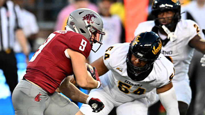 Aug 30, 2025; Pullman, Washington, USA; Washington State Cougars running back Kirby Vorhees (9) carries the ball against Idaho Vandals defensive lineman Titus Ringor (54) in the first half at Gesa Field at Martin Stadium. Mandatory Credit: James Snook-Imagn Images