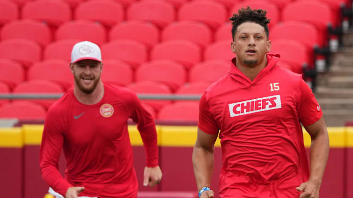 Aug 22, 2024; Kansas City, Missouri, USA; Kansas City Chiefs quarterback Patrick Mahomes (15) and quarterback Carson Wentz (11) warm up against the Chicago Bears prior to a game at GEHA Field at Arrowhead Stadium. Mandatory Credit: Denny Medley-Imagn Images