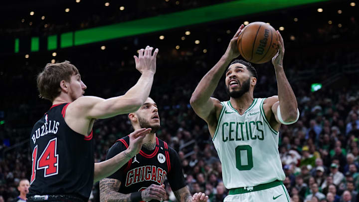 Dec 19, 2024; Boston, Massachusetts, USA; Boston Celtics forward Jayson Tatum (0) drives to the basket against Chicago Bulls guard Lonzo Ball (2) and forward Matas Buzelis (14) in the first quarter at TD Garden. Mandatory Credit: David Butler II-Imagn Images