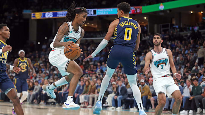 Dec 1, 2024; Memphis, Tennessee, USA; Memphis Grizzlies guard Ja Morant (12) passes the ball as Indiana Pacers guard Tyrese Haliburton (0) defends during the second quarter at FedExForum. Mandatory Credit: Petre Thomas-Imagn Images