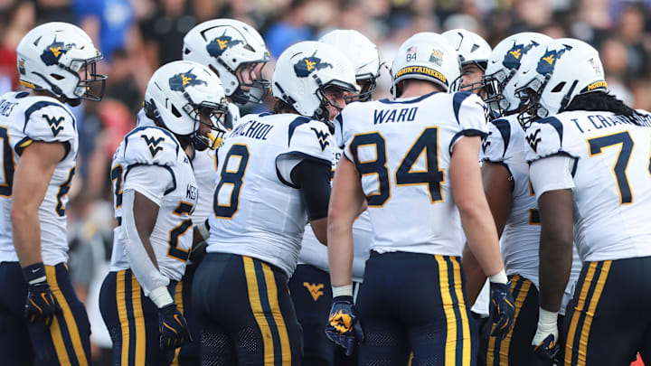 West Virginia Mountaineers quarterback Nicco Marchiol (8) brings his team in before a play during the first half of the game against Kansas Jayhawks at David Booth Kansas Memorial Stadium on Sept. 20, 2025.