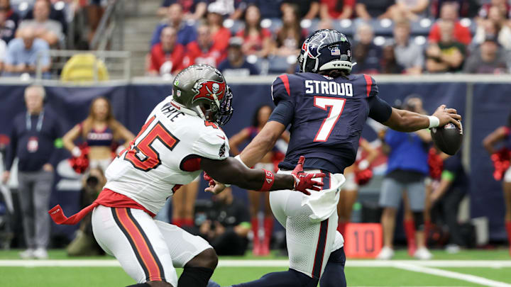 Nov 5, 2023; Houston, Texas, USA;  Houston Texans quarterback C.J. Stroud (7) escapes the grasp on Tampa Bay Buccaneers linebacker Devin White (45) in the first quarter at NRG Stadium. Mandatory Credit: Thomas Shea-Imagn Images