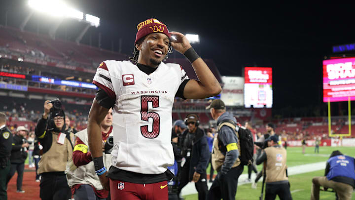 Jan 12, 2025; Tampa, Florida, USA; Washington Commanders quarterback Jayden Daniels (5) celebrates after winning a NFC wild card playoff against the Tampa Bay Buccaneers at Raymond James Stadium. Mandatory Credit: Nathan Ray Seebeck-Imagn Images