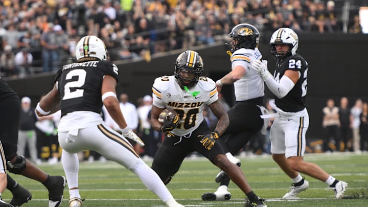 Oct 25, 2025; Nashville, Tennessee, USA; Missouri Tigers running back Jamal Roberts (20) runs the ball while defended by Vanderbilt Commodores safety Randon Fontenette (2) during the third quarter at FirstBank Stadium. Mandatory Credit: Steve Roberts-Imagn Images