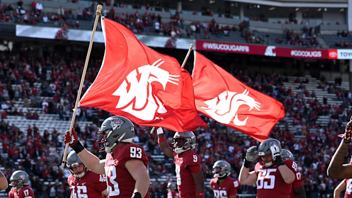 Oct 19, 2024; Pullman, Washington, USA; Washington State Cougars edge Jack Janikowski (93) and Washington State Cougars wide receiver Kyle Maxwell (9) carry school flags onto the field before a game against the Hawaii Warriors in the first half at Gesa Field at Martin Stadium. Mandatory Credit: James Snook-Imagn Images