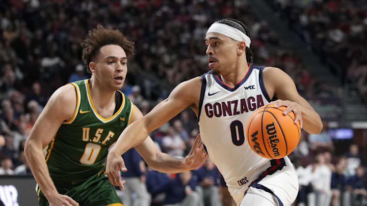 Gonzaga Bulldogs guard Ryan Nembhard (0) dribbles the basketball against San Francisco Dons guard Ryan Beasley (0) during the first half in the semifinal of the West Coast Conference tournament at Orleans Arena