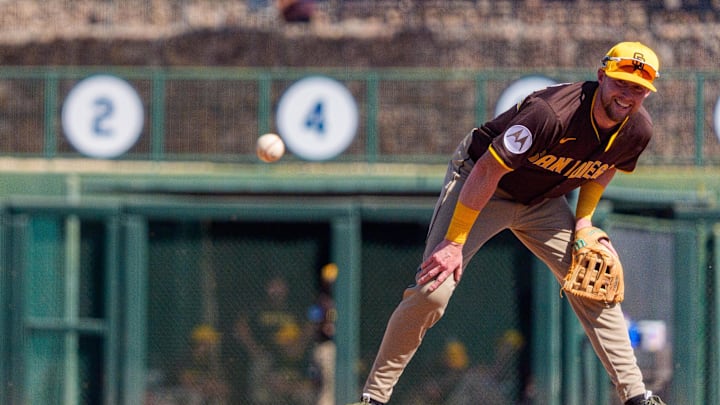 Feb 26, 2025; Phoenix, Arizona, USA; San Diego Padres infielder Jake Cronenworth (9) reacts to the ball spinning towards him during the third inning of a spring game against the Chicago White Sox at Camelback Ranch-Glendale. Mandatory Credit: Allan Henry-Imagn Images