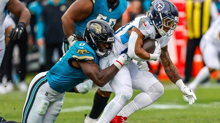 Jacksonville Jaguars linebacker Devin Lloyd (0) tackles Tennessee Titans running back Tony Pollard (20) during the third quarter in an NFL football matchup at EverBank Stadium, Sunday, Jan. 4, 2026, in Jacksonville, Fla. The Jaguars defeated the Titans 41-7 [Doug Engle/Florida Times-Union]