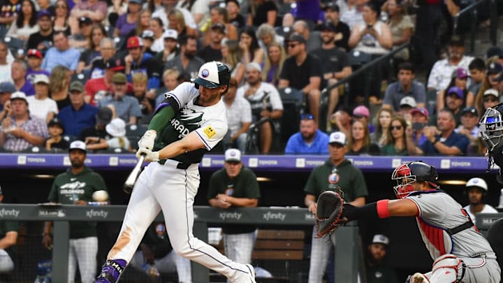 Colorado Rockies third baseman Ryan McMahon (24) hits a single against the Washington Nationals in the third inning at Coors Field on June 22.