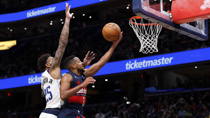 Nov 8, 2025; Washington, District of Columbia, USA; Washington Wizards guard CJ McCollum (3) shoots the ball as Dallas Mavericks forward P.J. Washington (25) defends in the second half at Capital One Arena. Mandatory Credit: Geoff Burke-Imagn Images