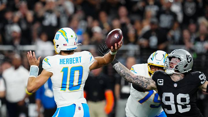 Sep 15, 2025; Paradise, Nevada, USA; Las Vegas Raiders defensive end Maxx Crosby (98) attempts to stop a pass from Los Angeles Chargers quarterback Justin Herbert (10) during the second quarter at Allegiant Stadium. Mandatory Credit: Stephen R. Sylvanie-Imagn Images Sep 15, 2025; Paradise, Nevada, USA; Las Vegas Raiders defensive end Maxx Crosby (98) attempts to stop a pass from Los Angeles Chargers quarterback Justin Herbert (10) during the second quarter at Allegiant Stadium. Mandatory Credit: Stephen R. Sylvanie-Imagn Images