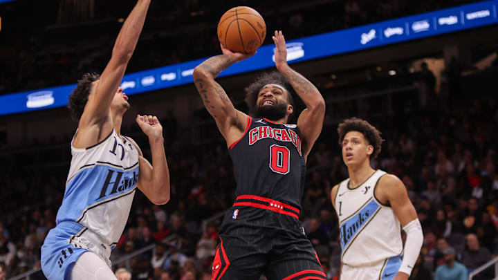 Dec 26, 2024; Atlanta, Georgia, USA; Chicago Bulls guard Coby White (0) shoots over Atlanta Hawks forward Zaccharie Risacher (10) in the fourth quarter at State Farm Arena. Mandatory Credit: Brett Davis-Imagn Images Dec 26, 2024; Atlanta, Georgia, USA; Chicago Bulls guard Coby White (0) shoots over Atlanta Hawks forward Zaccharie Risacher (10) in the fourth quarter at State Farm Arena. Mandatory Credit: Brett Davis-Imagn Images