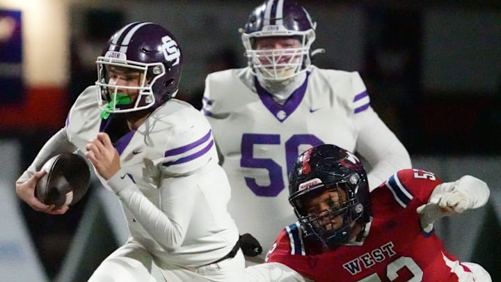 Sevier County's Cooper Newman (7) runs the ball ahead of West's Camarin Leggett (52) during a TSSAA high school football playoff game on Friday, Nov. 22, 2024, in Knoxville, Tenn. Sevier County's Cooper Newman (7) runs the ball ahead of West's Camarin Leggett (52) during a TSSAA high school football playoff game on Friday, Nov. 22, 2024, in Knoxville, Tenn.