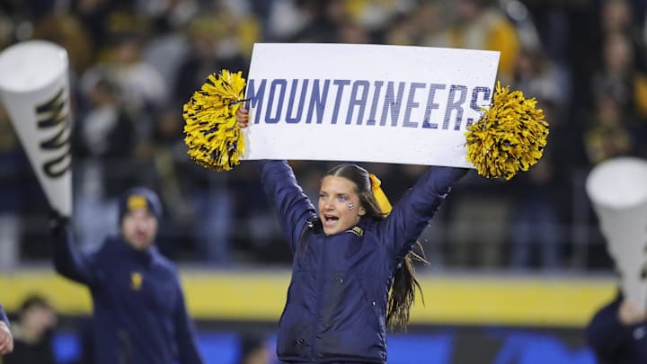 Nov 23, 2024; Morgantown, West Virginia, USA; A West Virginia Mountaineers cheerleader performs during the third quarter against the UCF Knights at Mountaineer Field at Milan Puskar Stadium. Mandatory Credit: Ben Queen-Imagn Images