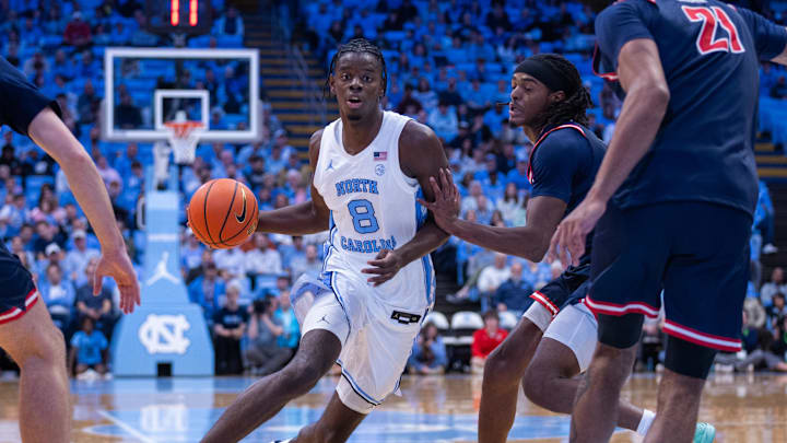 Nov 11, 2025; Chapel Hill, North Carolina, USA; North Carolina Tar Heels forward Caleb Wilson (8) drives past Radford Highlanders guard Jr. Dennis Parker (11) during the second half at Dean E. Smith Center. 