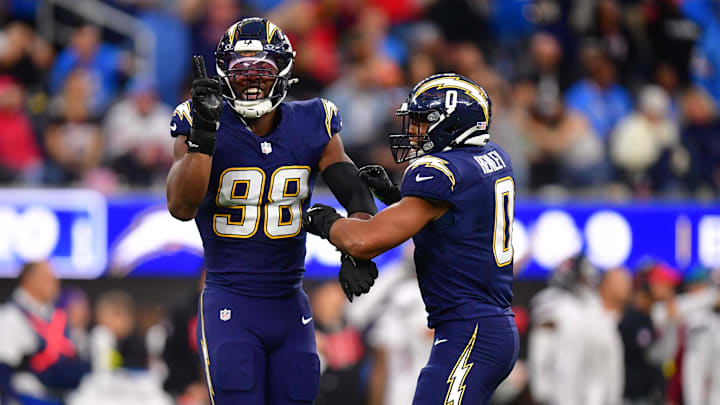 Odafe Oweh celebrates after a sack with Daiyan Henley.