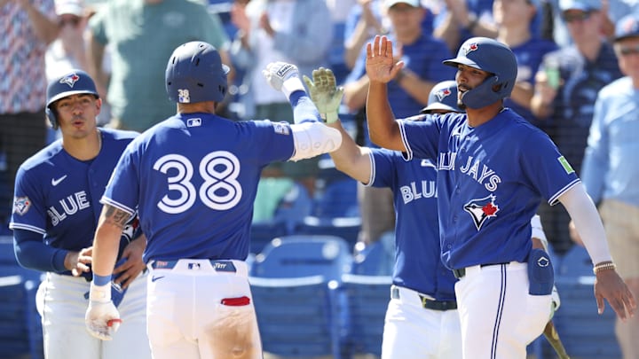 Toronto Blue Jays shortstop Josh Rivera reacts to Nathan Lukes after hitting a grand slam.
