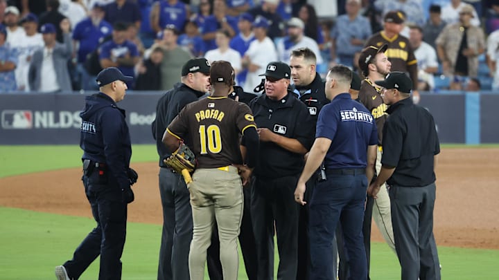 Oct 6, 2024; Los Angeles, California, USA; San Diego Padres outfielder Jurickson Profar (10) talks with umpires and security in the seventh inning against the Los Angeles Dodgers during game two of the NLDS for the 2024 MLB Playoffs at Dodger Stadium. Mandatory Credit: Kiyoshi Mio-Imagn Images Oct 6, 2024; Los Angeles, California, USA; San Diego Padres outfielder Jurickson Profar (10) talks with umpires and security in the seventh inning against the Los Angeles Dodgers during game two of the NLDS for the 2024 MLB Playoffs at Dodger Stadium. Mandatory Credit: Kiyoshi Mio-Imagn Images