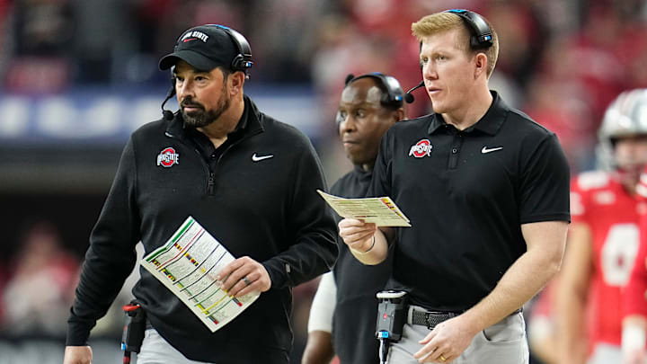 Ohio State Buckeyes tight ends coach Keenan Bailey, right, and head coach Ryan Day walk along the sideline during the Big Ten Conference championship game at Lucas Oil Stadium in Indianapolis on Dec. 6, 2025. Ohio State lost 13-10.