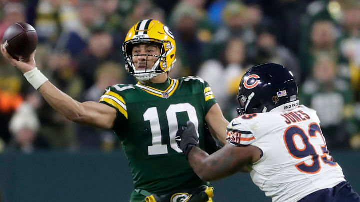 Green Bay Packers quarterback Jordan Love (10) throws under pressure from Chicago Bears defensive tackle Justin Jones (93) during their football game Sunday, January 7, 2024, at Lambeau Field in Green Bay, Wis. The Packers defeated the Bears 17-9.
