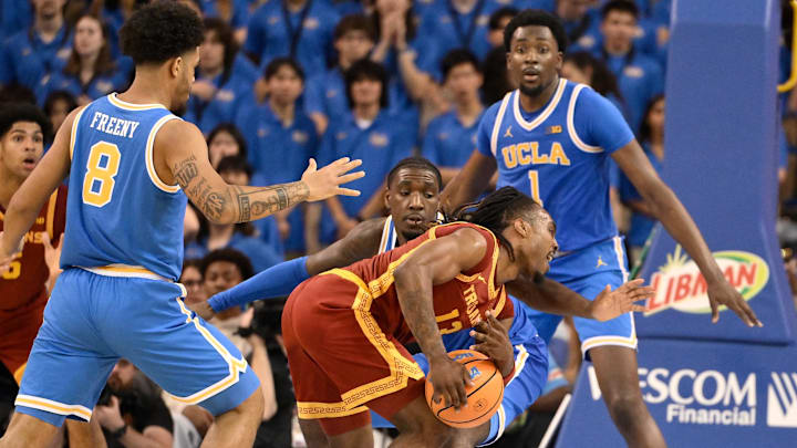 Feb 24, 2026; Los Angeles, California, USA;  Southern California Trojans guard Kam Woods (13) is surrounded by UCLA Bruins guards Eric Freeny (8), Eric Dailey Jr. (3) and forward Xavier Booker (1) during the second half at Pauley Pavilion presented by Wescom Financial. Mandatory Credit: Robert Hanashiro-Imagn Images