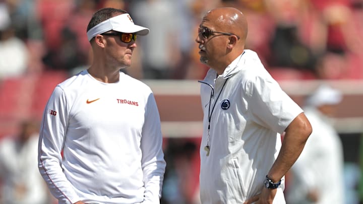 Oct 12, 2024; Los Angeles, California, USA; USC Trojans head coach Lincoln Riley, left, talks with Penn State Nittany Lions head coach James Franklin on the field prior to the game at United Airlines Field at Los Angeles Memorial Coliseum. Mandatory Credit: Jayne Kamin-Oncea-Imagn Images