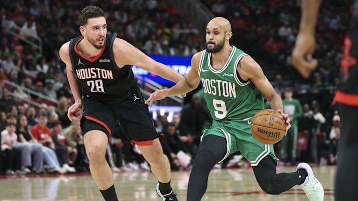 Feb 4, 2026; Houston, Texas, USA; Boston Celtics guard Derrick White (9) drives with the ball as Houston Rockets center Alperen Sengun (28) defends during the third quarter at Toyota Center. Mandatory Credit: Troy Taormina-Imagn Images
